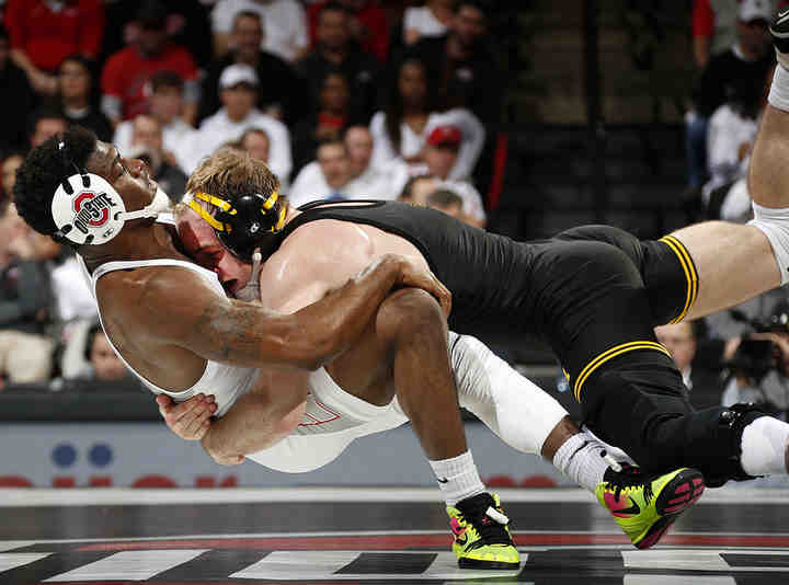 Ohio State's Te'Shan Campbell gets taken down by Iowa's Alex Marinelli during their 165 pound match at Value City Arena in Columbus. Marinelli won Dec 4-1.   (Kyle Robertson / The Columbus Dispatch)